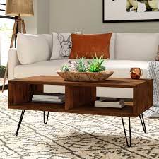 The coffee tables themselves are set on black geometric wireframes with thick, heavy tops that create stability. Union Rustic Whitaker Coffee Table With Storage Reviews Wayfair