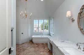 White And Gray Master Bathroom Features A Freestanding Tub Positioned On Hexagon Terracotta Floor Til Rustic Flooring Terracotta Floor Gray Tile Bathroom Floor