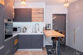 Bar stools come in all shapes, sizes and colors. Modern Kitchen Interior With Lights On Brown Wooden Table And Stock Photo Picture And Royalty Free Image Image 116618276