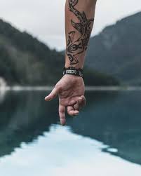 Find over 100+ of the best free hand tattoo images. Tattoo Hand Of Person Pointing To Body Of Water With Wrist Tattoo Holding Hands Image Free Stock Photo