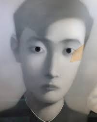 As you make your way up the escalator to our restaurant, take a moment to  appreciate the striking oil portrait by Zhang Xiao Gang, “Bloodline: Big  Family