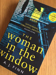 An agoraphobic woman living alone in new york begins spying on her new neighbors, only to witness a disturbing act of violence. The Woman In The Window By A J Finn Mum Of Three World