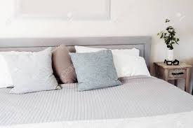 The bedside tables have numerous purposes, for instance offering convenient storage within arm's reach and providing balance to the arrangement of your room. Clean Bright And Airy Bedroom With Grey Bed Light Blue Cream Stock Photo Picture And Royalty Free Image Image 139157738