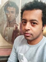 A modern Egyptian man taking a selfie with a 2000-year-old portrait of an  Egyptian man from the Roman era.