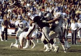 Raiders' DE Lyle Alzado (77) steams past Denver G/T Mark Cooper (63)