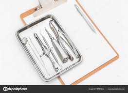 Dental Tools Equipment And Dental Chart On White Background