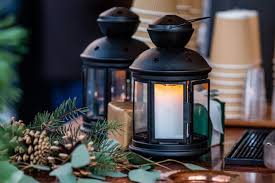 Glowing Candle Lantern And Christmas Decorations On The Table In The Christmas Market In Riga Latvia Premium Photo