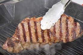 Heat a 12 cast iron skillet over high heat until it starts to smoke, then drizzle in the canola oil. Easy Tips For Cooking Steak On A Griddle Like Never Before