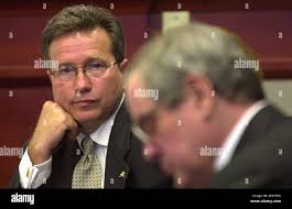 Marcus Triplett, left, listens to proceedings in Judge Foxman's DeLand  courtroom Monday, April 21, 2003, in DeLand, Fla. Triplett, a pastor with  Abundant Life Ministries, represents his church corporation which is charged