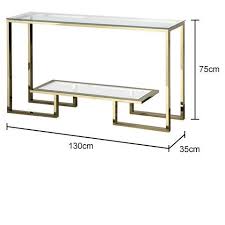 Rectangular metal tube / 5mm tempered clear glass sleek contemporary black metal console sofa table create an elegant atmosphere in your home. Angular Glass Top Console Table In Gold Console Table Decorating Metal Furniture Design Coffee Table Design Modern