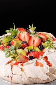 Pavlova is basically a giant meringue that gets topped with whipped cream and berries. Pavlova Meringue Cake Dessert Made With Strawberries Kiwi Blueberries And Mint Stock Photo Image Of Ornate Mint 138501502