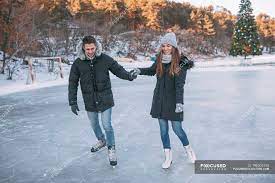 Check spelling or type a new query. Couple Holding Hands While Ice Skating On Rink Ice Skate Focus On Foreground Stock Photo 196303190