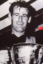 1957. Fitzroy half-forward Don Furness, who kicked the winning goal, with  Melbourne captain John Beckwith, Fitzroy secretary Ward Stuchberry,  Melbourne coach Norm Smith (still looking dazed at Fitzroy's win), Fitzroy  ruckman Eddie