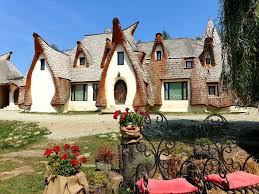 Resembling a gnome village, the castelul de lut complex has been created from clay, sand and pure whimsy. Castelul De Lut Valea Zanelor Porumbacu De Sus Romania Romania Travel House Styles Travel Bucket