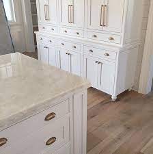 Off white kitchen cabinets with brass hardware. Kitchen White Inset Cabinets With Antique Brass Hardware And Marble Tops Make For A Great Kitche Brass Kitchen Hardware Gold Kitchen Hardware Kitchen Hardware