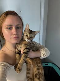 My mama loves her cat, Pumpkin! He's half her size lol