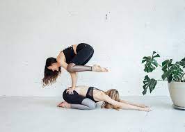 This easy yoga pose for two stretches the hamstrings. 6 Partner Yoga Moves Anyone Can Do Om The City