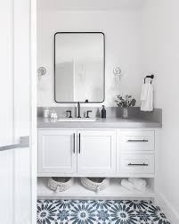 Large soaking tub is framed in black and white. Matte Black Bath Vanity Hardware Design Ideas