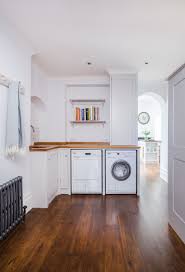 My laundry room contains a hot water heater (behind a screen), ceramic top range, commercial ice maker, washer, dryer and an oak mantel hung on the wall that i decorate seasonally, in addition to stepping stools, cleaning supplies, extra light bulbs in a cabinet above the washer/dryer and no telling what else. The Hardworking Utility Room Charlie Kingham Bespoke Utility Room