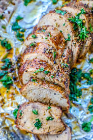 This pork is seasoned with a spiced apple butter, and roasted in apple juice. The Best Baked Garlic Pork Tenderloin Recipe Ever