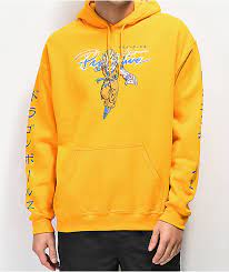 She wears an orange vest with golden yellow upper linings with a lavender hoodie and a white short sleeve undershirt, pale blue denim long skirt. Primitive X Dragon Ball Z Nuevo Super Saiyan Goku Gold Hoodie Zumiez