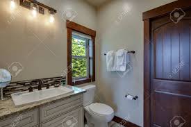 (don't substitute ammonia for vinegar as it can damage some cupboard finishes.) combine it well, then use clean cloths or sponges to scrub down the doors. New Luxury Bathrooms With Rich Color Wooden Doors Natural Beige Countertops White Cabinets And Sinks Bright Clean Grey Walls And Floor Stock Photo Picture And Royalty Free Image Image 142644018
