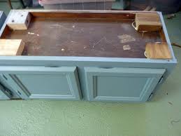 Cut a 4x4 or a 2x4 into blocks that will sit flush to the top of cabinet. Upcycle Kitchen Cabinets Into A Storage Bench How Tos Diy