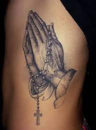 The beads are reminiscent of those carried worldwide by catholic grandmothers. Top 9 Cool And Stylish Praying Hands Tattoo Designs
