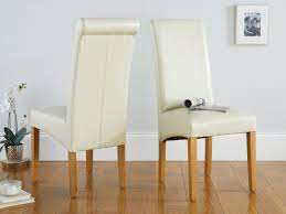 Exuding style and elegance with a fully upholstered frame and sleek black metal legs. Tuscan Cream Leather Dining Chair From Topfurniture
