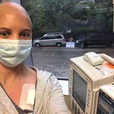 Husband holds sign outside for wife who has to go to chemotherapy alone  because of coronavirus