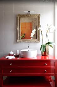 A bright red bathroom clad with bold mosaic tiles, a dark sink and pendant lamps. Bathroom Red Bathroom Vanity Designs Amazing Bathrooms