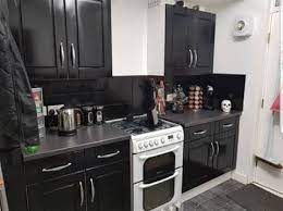 After all, they have such shiny surfaces, you couldn't possible paint them without ruining the finish right? Woman Spends 43 Transforming Her Kitchen Using Black Cupboard Paint And Enamel Spray