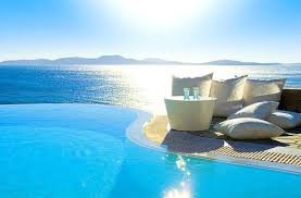 What With The Ocean Behind It Unreal Someone Slap Me I Must Be Dreaming Pool I Want To Lay On An Inflatable Poo Luxury Beach Resorts Grand Hotel Mykonos