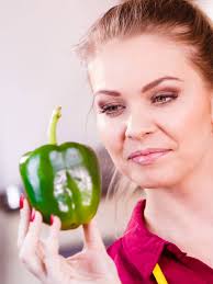 Close-Up Shot of a Person Holding Green Bell Peppers · Free Stock Photo