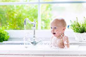 Download cute blonde baby taking bath in bathroom sink stock photo and explore similar images at adobe stock. Baby Taking Bath In Kitchen Sink Child Playing With Foam And Soap Bubbles In Sunny Bathroom