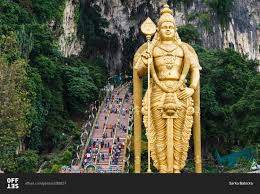 | guarded by a monumental statue of hindu deity lord murugan, the batu caves are a malaysian national treasure and an unmissable day trip from kuala lumpur. Golden Lord Murugan Statue Stands Below The Batu Caves In Malaysia Stock Photo Offset
