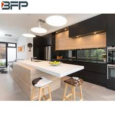 A patterned monochrome rug pops on wood surface and pampers the feet. China Customized Deisgn Modern Solid Wood Match Color Flat Panel Door Black Wood Grain Kitchen China Kitchen Cabinets Kitchen Products