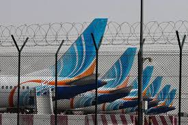 A Flydubai aircraft parked at an airport gate, with the airline's logo visible on the tail.