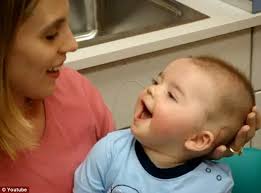 Five years after video of baby hearing his mother's voice for the first  time became an internet sensation his parents reveal he is making  'phenomenal progress' and is a 'flirt' in the