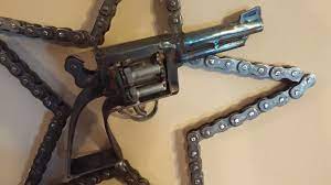 Motorcycle Chain Welded Solid To Form This Cool Star And A Hand Made Sixgun Make Up This Wall Hanging Scrap Metal Art Metal Art Projects Metal Working Projects