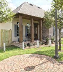 I used 38 grit sandpaper to remove old sealer that was peeling. Cypress Wooden Beams Acadian Style House Acadian Style House Front Porch Columns Brick Porch
