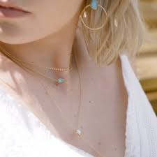 From Delicately Adorned Necklaces To Stackable Dainty Rings These Colour Pop Pieces With Vibrant Tu Video Dainty Jewelry Necklace Ear Jewelry Diamond Cross Pendants