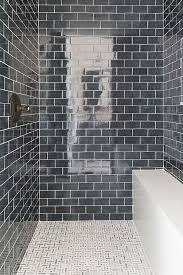 Subway tile is ideal for shower walls but cannot go on the shower floor. Charcoal Gray Stone Shower Bench Design Ideas