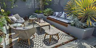 A small outdoor living room feels more expansive because a low wall focuses the eye upward and toward the garden beyond. Low Maintenance Garden Low Maintenance Garden Ideas