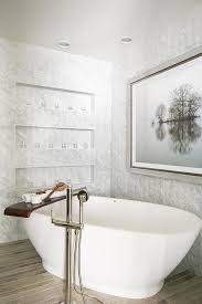 A Catty Corner Oval Bathtub Displaying A Teak Bath Shelf Tray Along With A Polished Nic Freestanding Tub Faucet Free Standing Bath Tub Basement Bathroom Design