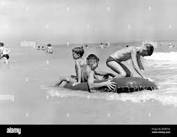 tourism, beach life, boys with rubber dinghy, 1960s,  ADDITIONAL-RIGHTS-CLEARANCE-INFO-NOT-AVAILABLE Stock Photo - Alamy