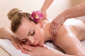 Strong hands doing massage on back of gorgeous female model in white spa during vacation relax. Woman Lying In A Beauty Parlour Enjoying Relaxing Back Massage Stock Photo Picture And Royalty Free Image Image 79377592