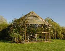 A Hexagonal Gazebo With A Horizontally Slatted Roof Perfect For Outdoor Dining And Growing Creeper Plants Gazebo Garden Room Garden Buildings