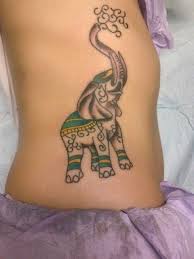 This line tattoo design is looking very cute. Classic Elephant Trunk Up Tattoo On Girl Right Side Rib