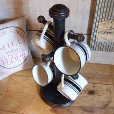 These styles typically hold fewer than six mugs and don't offer much in the way of storage. Primitive Coffee Cup Rack Mug Tree Stand Wooden Hand Finished Lamp Black Coffee Cup Rack Mug Tree Stand Coffee Cups